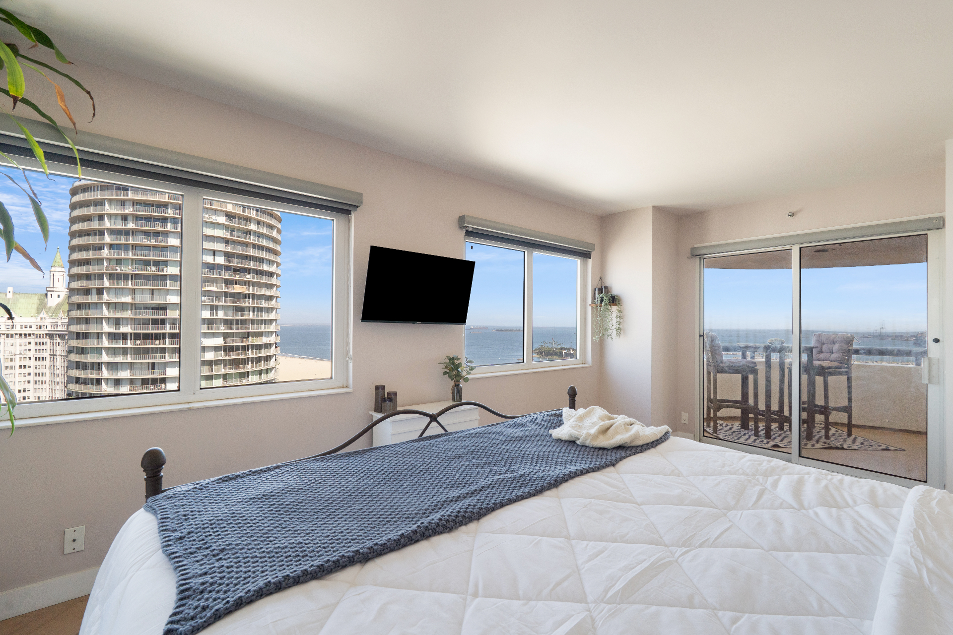 Second bedroom with king bed, TV, and private balcony with ocean views