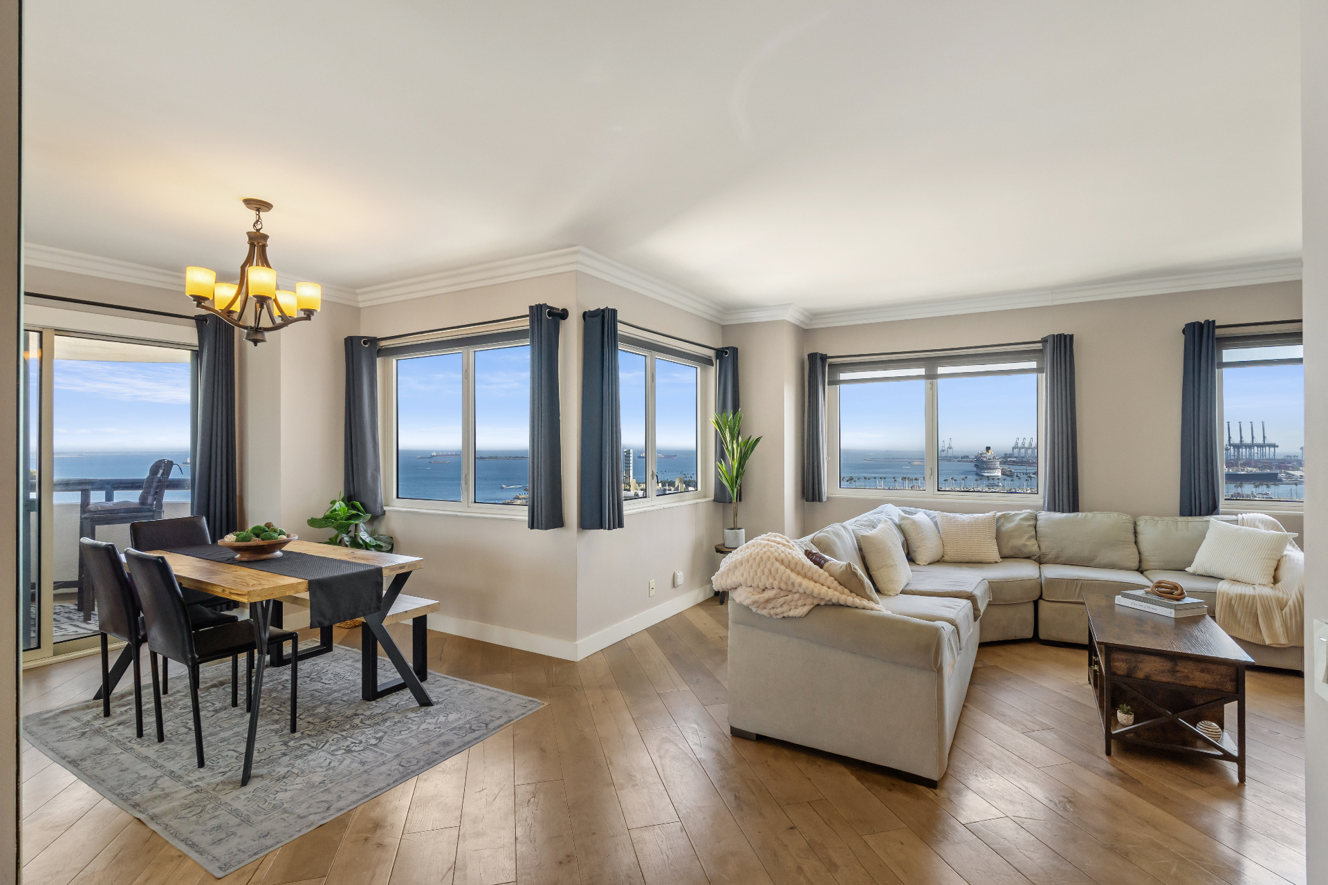 Open concept living and dining room with panoramic ocean and harbor views from 525 E Seaside Way #1909